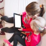 girls watching tablet
